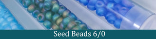Green and blue seed beads in tubes.