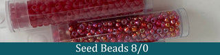 Red seed beads in clear tubes.
