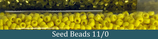 Clear tube of yellow seed beads.