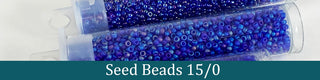 Clear tubes of blue seed beads.