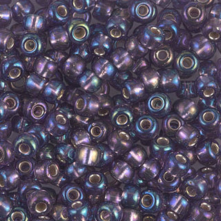 Closeup of size 6/0 silver lined Amethyst Miyuki seed beads.
