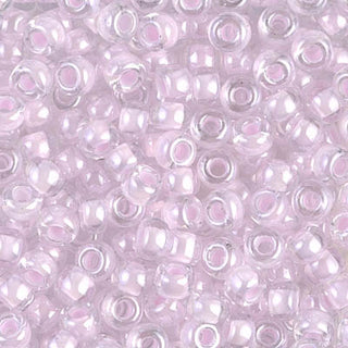 Closeup of size 6/0 pink lined crystal Miyuki seed beads.