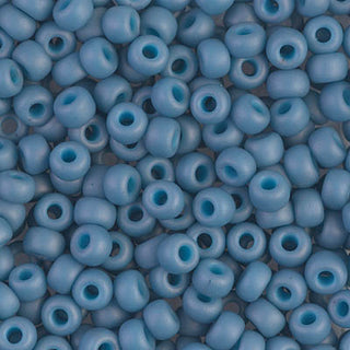 Closeup of size 6/0 matte OP pale denim luster Miyuki seed beads.