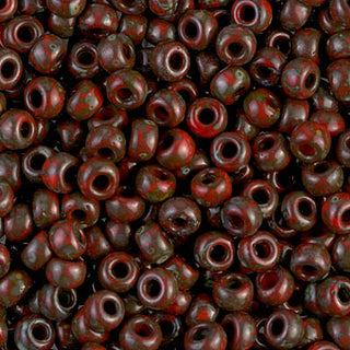 Closeup of size 6/0 opaque red picasso Miyuki seed beads.