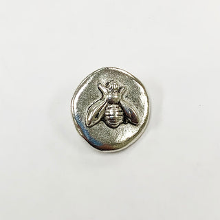 Small round silver button with raised bee embossed.