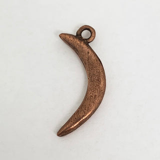 Back side of copper crescent shaped charm.