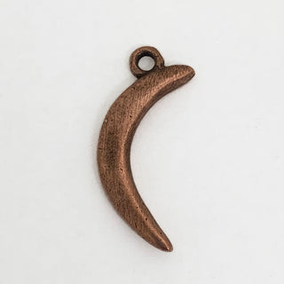 Front side of copper crescent shaped charm.