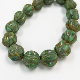 Strand of seagreen/picasso Czech glass melon beads.