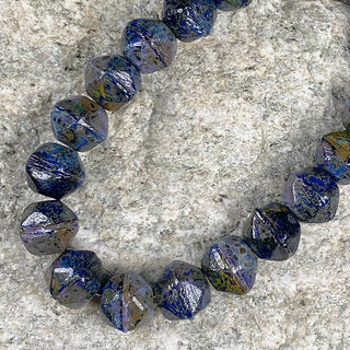 Strand of 8mm English cut sapphire with picasso Czech glass beads.