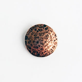 Small round hammered antique copper button.