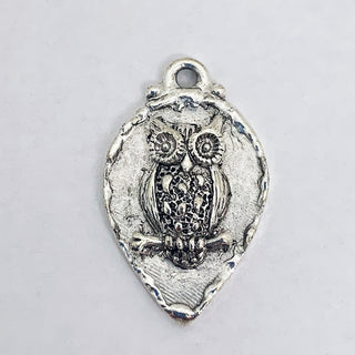 Silver plated teardrop charm with raised owl and edge.