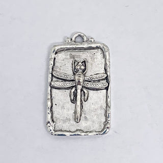 Silver plated hammered rectangular pendant with raised dragonfly and rim.