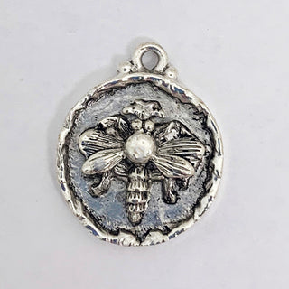 Silver plated round pendant with embossed bee and rim.