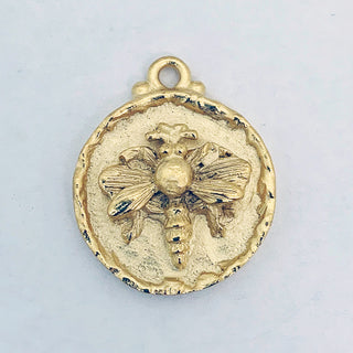 Satin Gold plated round charm with embossed bee and rim.