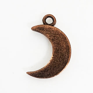 Back side of textured copper tone crescent shaped charm.