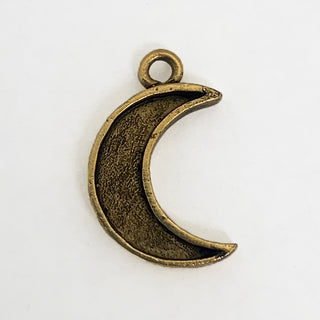 Front side of textured gold tone crescent shaped charm with lip.