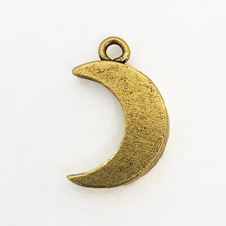 Back side of textured gold tone crescent shaped charm.