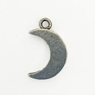 Reverse side of textured silver tone crescent shaped charm.