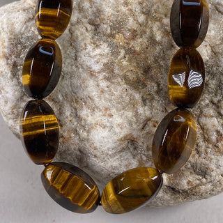 Tiger eye faceted oval 20x12mm beads strand.