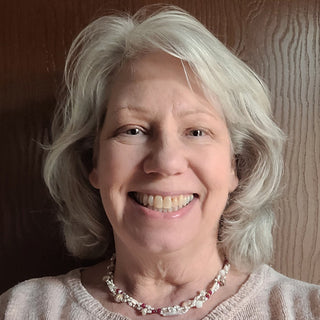 Headshot of Kit Coordinator Karen wearing a pearl themed beaded necklace.