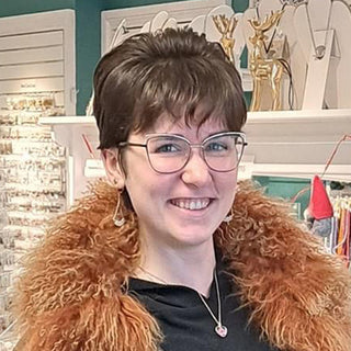 Lydia who works at the front counter wearing some of her handcrafted jewelry.