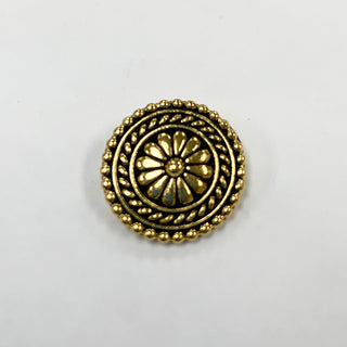 Small round gold tone flower textured button with embellished edges.