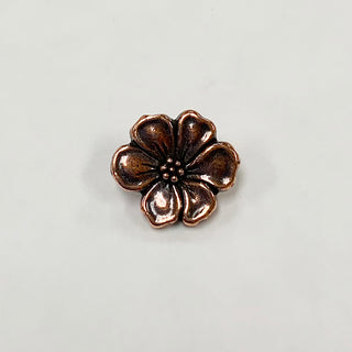Antique copper metal button shaped like an apple blossom.