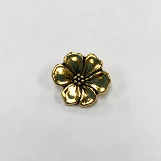 Antique gold plated metal button shaped like an apple blossom.