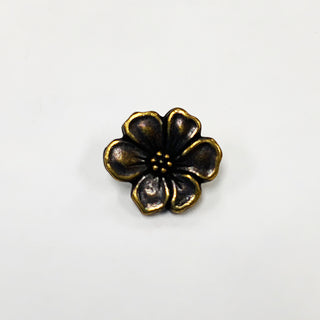 Brass Oxide  metal button shaped like an apple blossom.