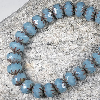 Strand of 8mm Czech glass 7x10mm sky blue with picasso cruller beads.
