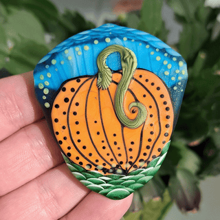back of lampwork glass bead of  pumpkin
