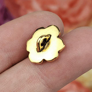Antique gold plated metal button shaped like an apple blossom