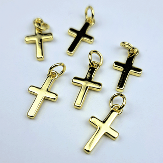 6 gold cross charms on white background