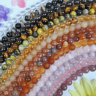 several different colored gemstone crystal strands arranged like a rainbow