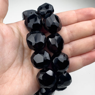 Black Onyx approx 15-18mm Faceted Nuggets 7in Strand (11 Beads) in hand