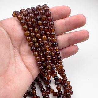 Hessonite Garnet 6mm 15.5in Round in hand