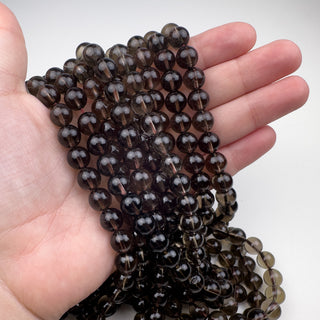 Smoky Quartz 9mm Round 15.5in Strand in hand