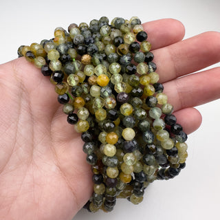 Prehnite 5mm Round Faceted 15.5in Strand in hand