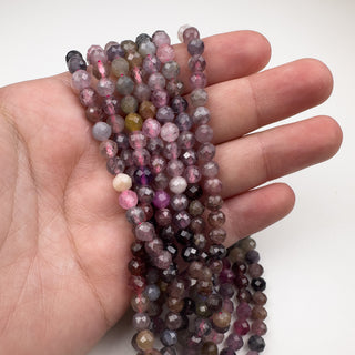 Spinel 5mm Round Faceted 15.5in Strand in hand