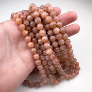 Peach Moonstone 8mm 15.5in Round in hand