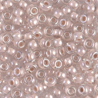 Closeup of size 6/0 blush lined crystal Miyuki seed beads.