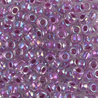 Closeup of size 6/0 raspberry lined crystal AB Miyuki seed beads.