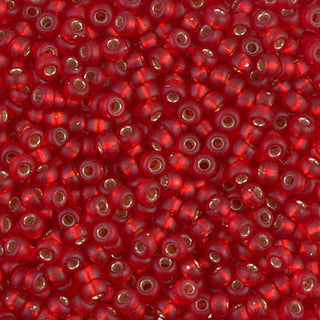 Closeup of size 8/0 matte flame red silver lined Miyuki seed beads.