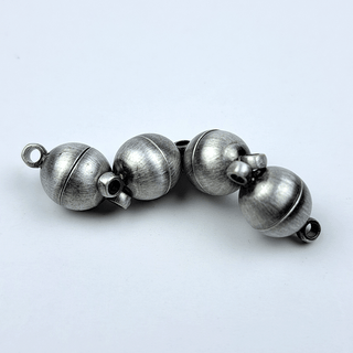 4 silver magnets on white background