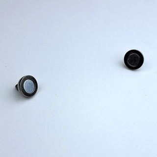 32 halves of a silver magnet on white backgorund