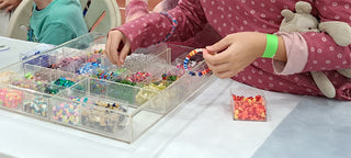 Children making bracelets at our Bracelet Bead Bar.