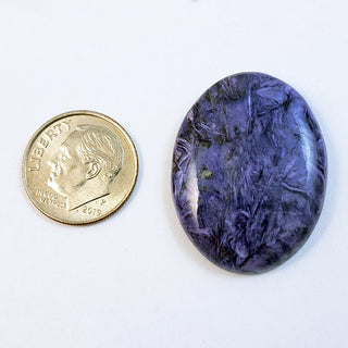 Charoite cabochon, 23x31mm oval, next to a dime for scale.