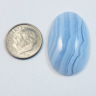 Blue Lace Agate cabochon, 19x31mm oval, next to a dime for scale.