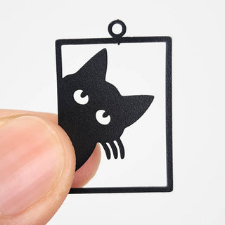 black stainless steel charm that looks like a cat peering out of a window frame