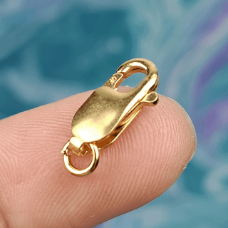 gold clasp on finger